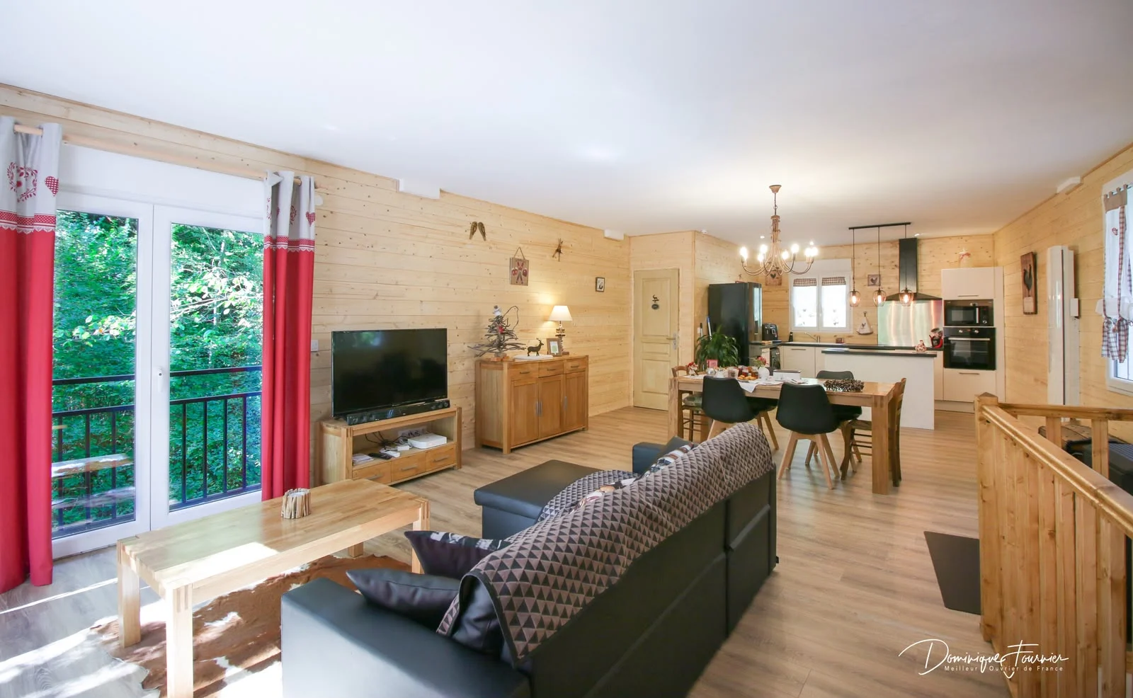Bright open-plan living space overlooking the forest at Au Moulin